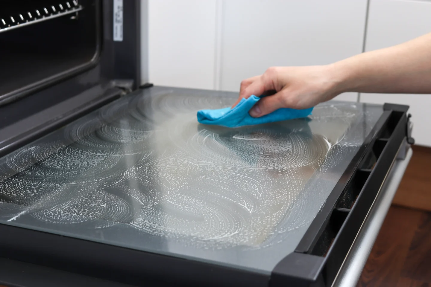 Uunin lasin pyyhkiminen pesuaineella