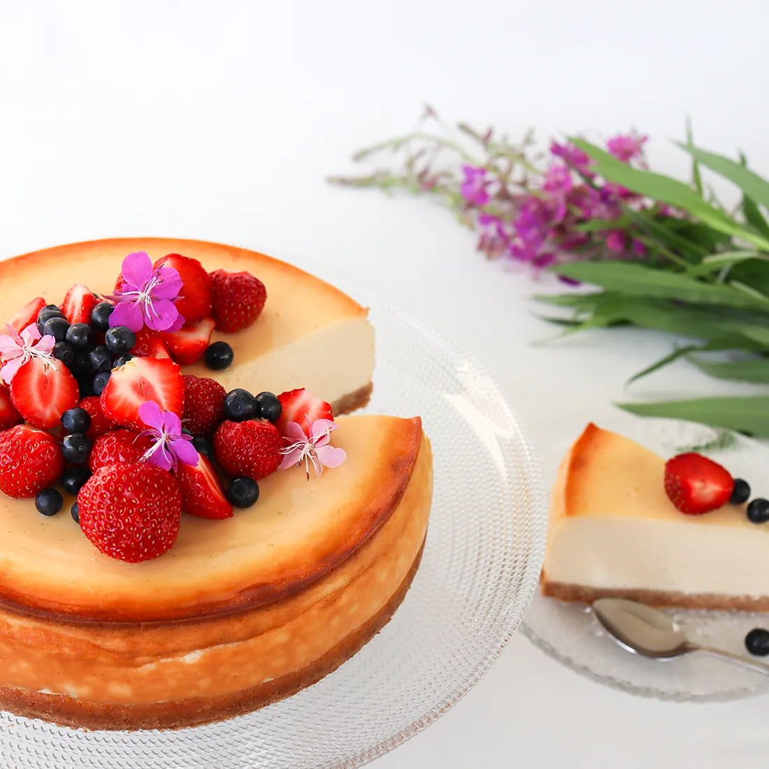 Juustokakku uunissa paistamisen ja jäähtymisen jälkeen, marjoilla koristeltuna.