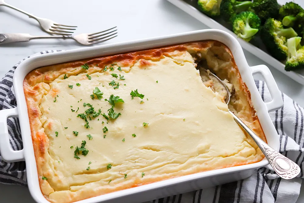 Lihaperunasoselaatikko tuoreen persiljan kanssa.