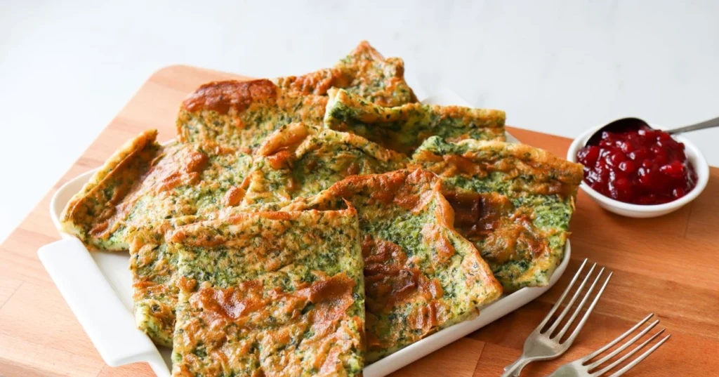 Pinaattipannukakku neliskulmaisiksi paloiksi leikattuna.