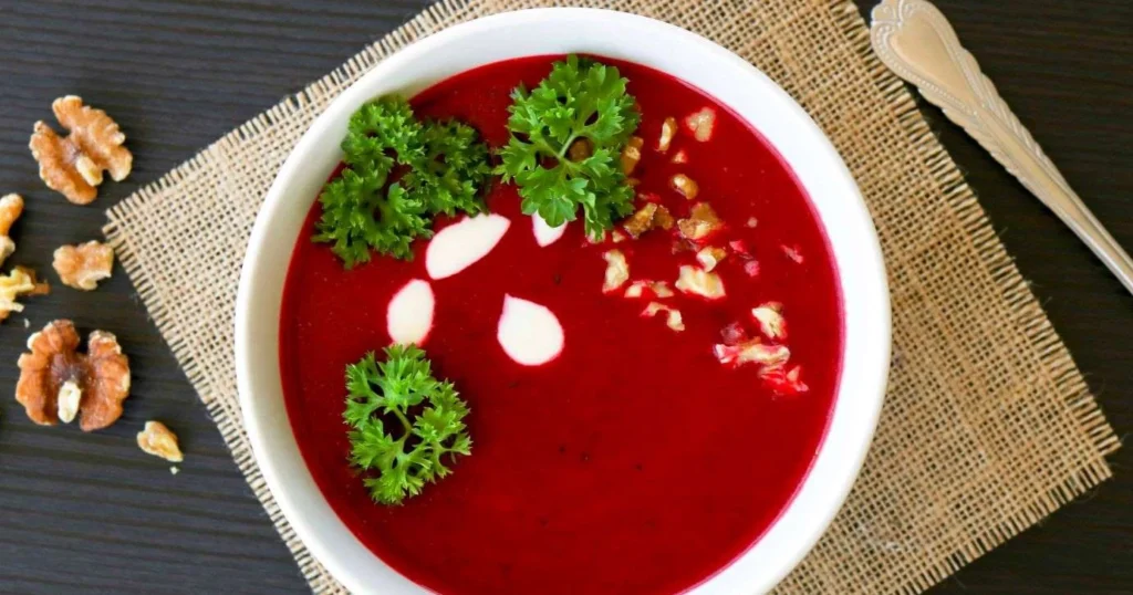 Punajuurikeittoa ja pähkinöitä lautasella.